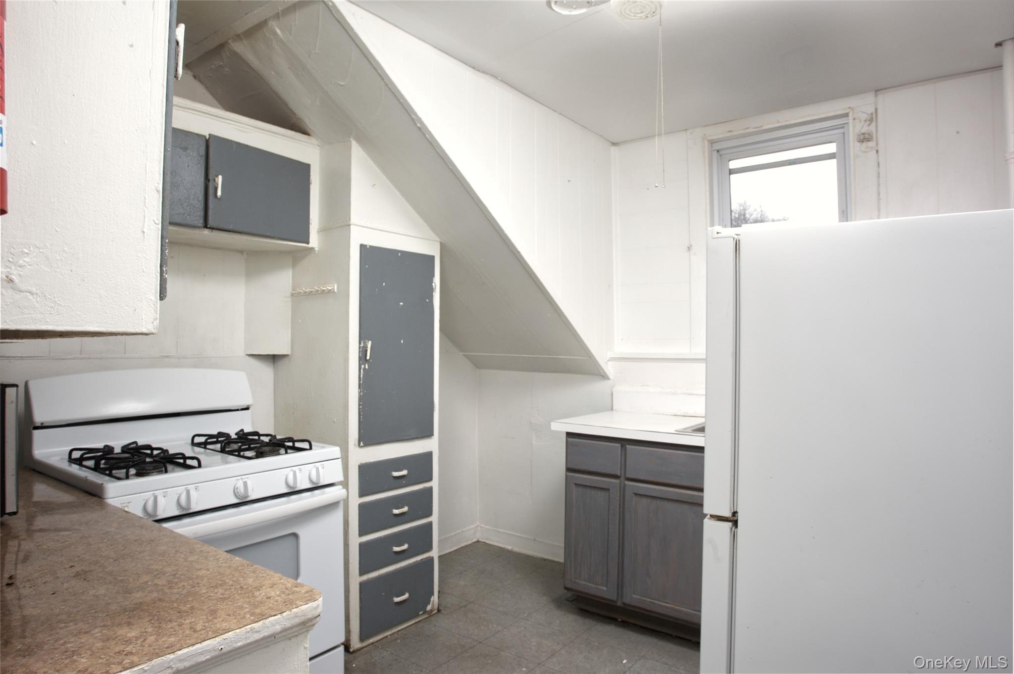 119 Chambers Street Newburgh, NY 12550 - Photo 3 of 18 a kitchen with a stove and a microwave