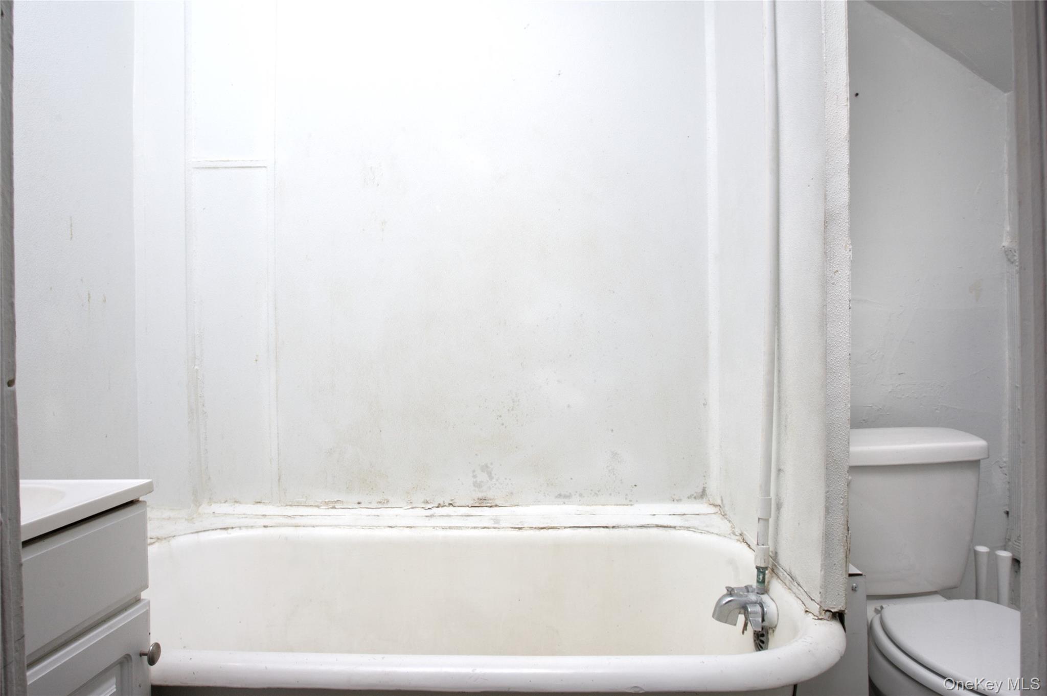 119 Chambers Street Newburgh, NY 12550 - Photo 4 of 18 a bathroom with a bathtub and a toilet