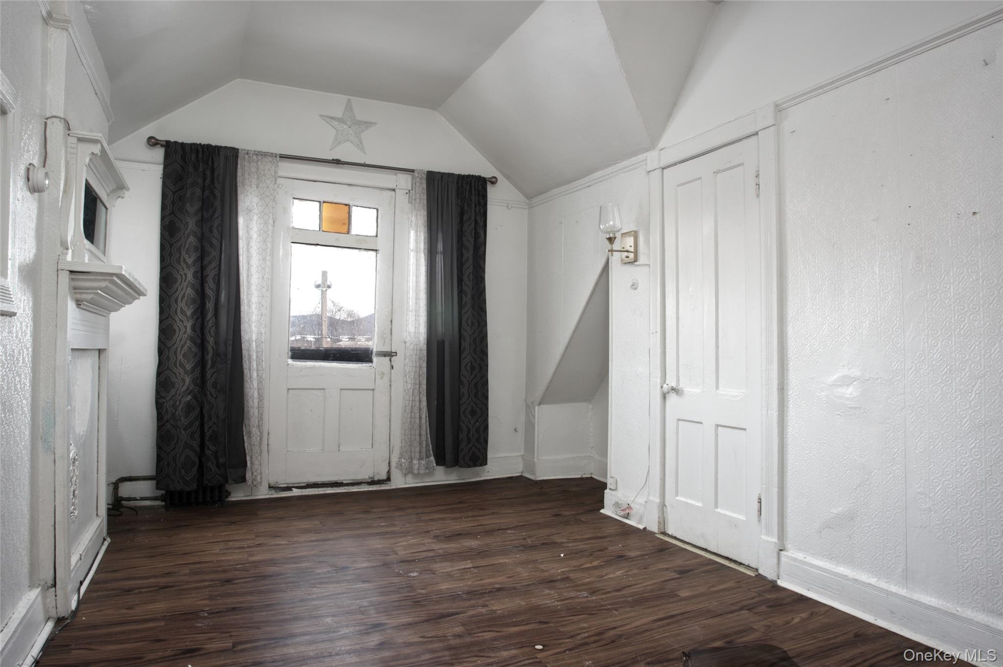 119 Chambers Street Newburgh, NY 12550 - Photo 5 of 18 an empty room with wooden floor and a window