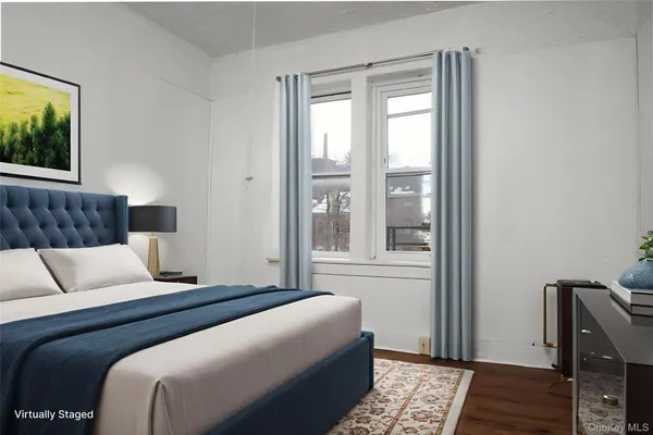 a bedroom with a bed and a couch