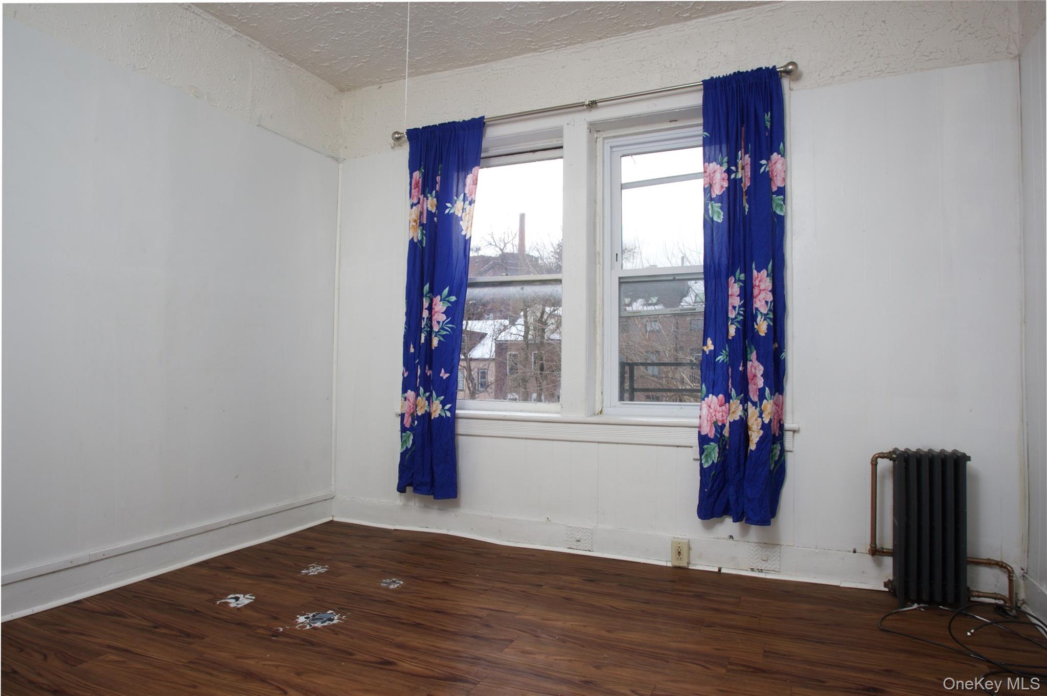 119 Chambers Street Newburgh, NY 12550 - Photo 8 of 18 a view of empty room with wooden floor and fan