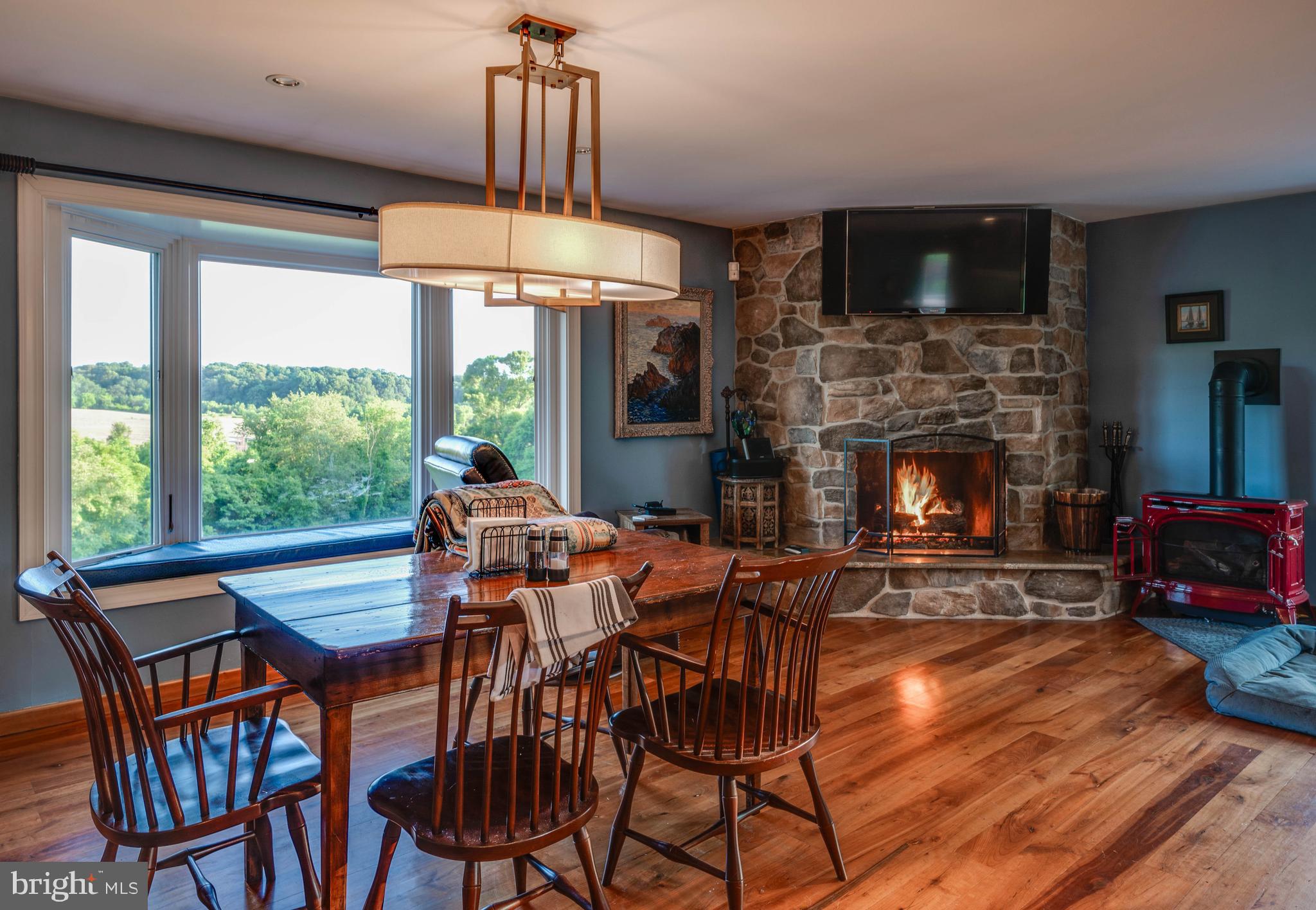 2600 Garrett Road White Hall, MD 21161 - Photo 53 of 65 a dining room with furniture a fireplace and wooden floor