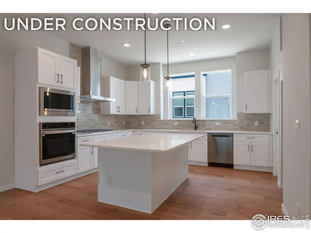 a large kitchen with kitchen island granite countertop a sink window and stainless steel appliances