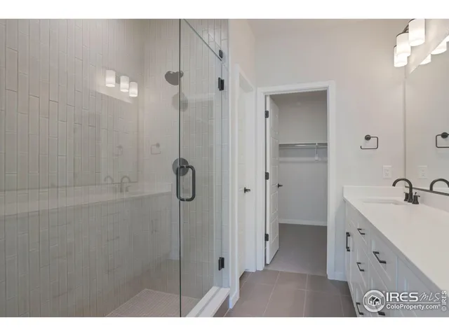 a bathroom with a shower sink and mirror