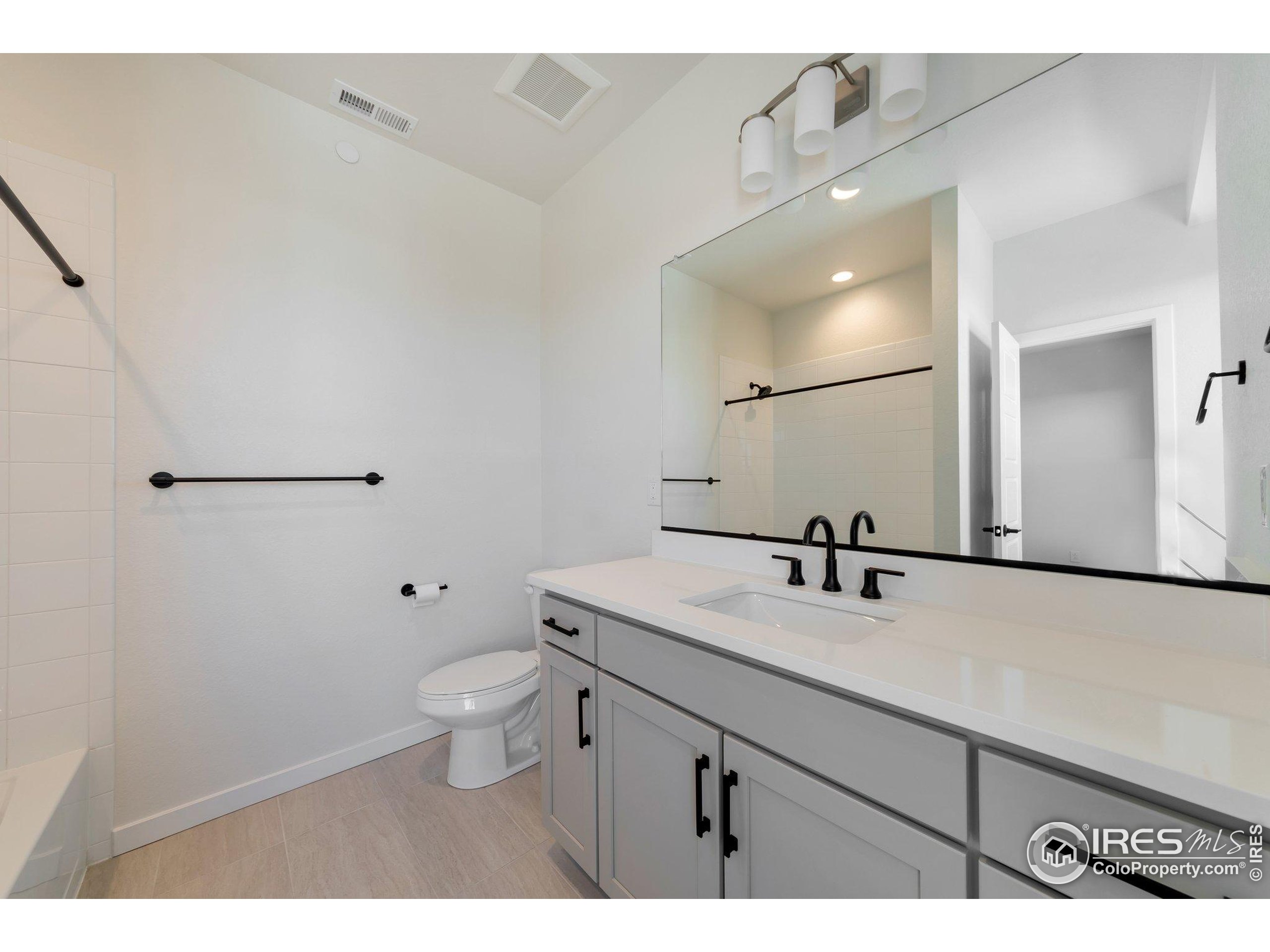 352 Marshall Road Superior, CO 80027 - Photo 16 of 30 a bathroom with a sink a toilet and mirror