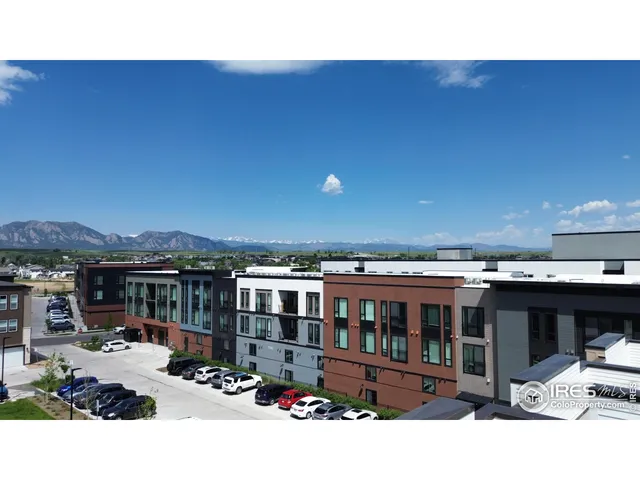 a view of a balcony with chairs and large trees