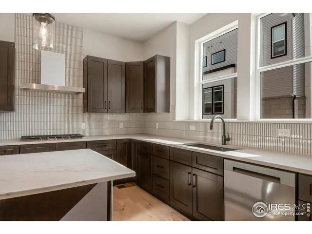 a kitchen that has a sink and a stove