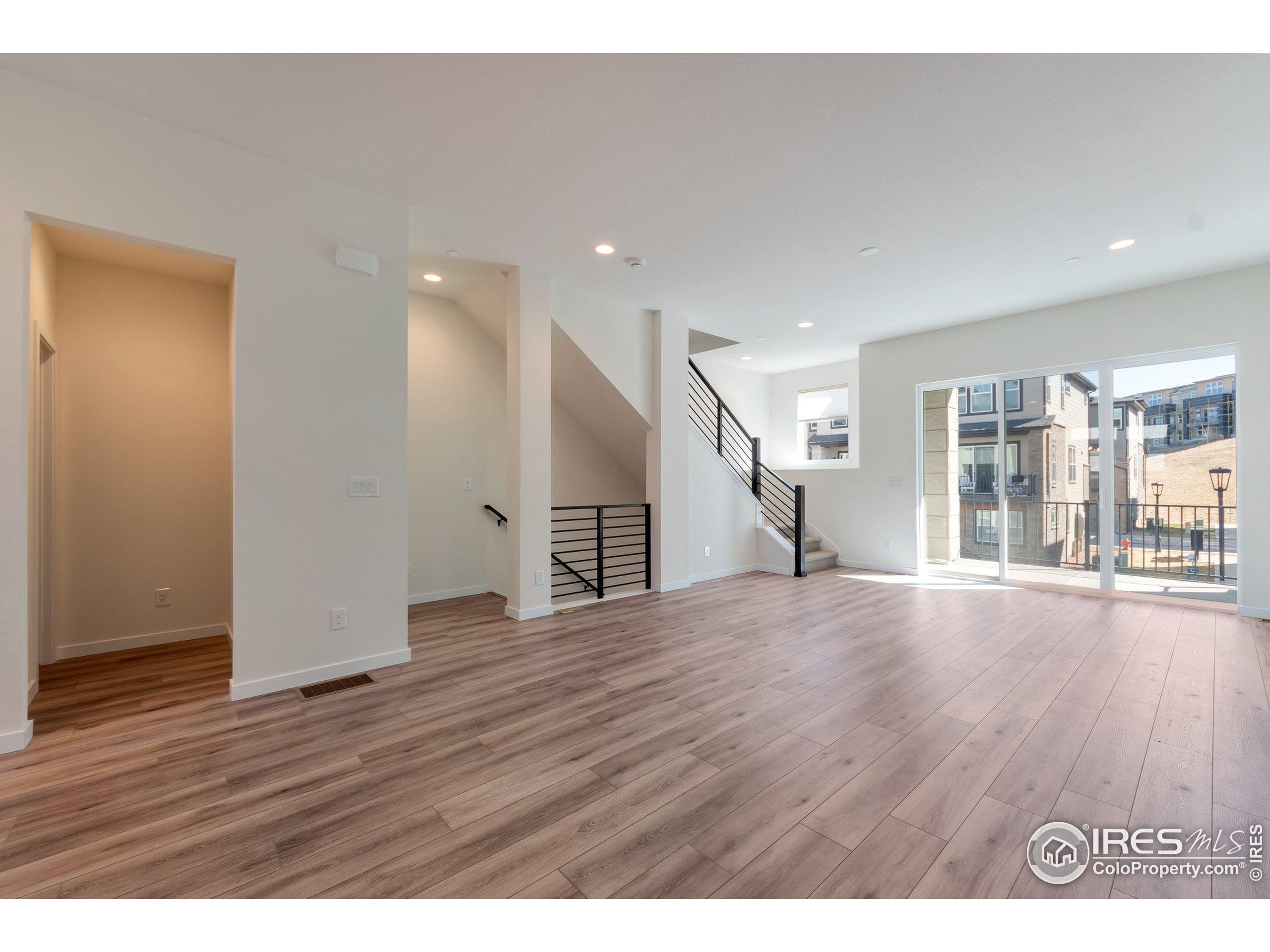 352 Marshall Road Superior, CO 80027 - Photo 7 of 30 a view of an empty room with wooden floor and a window