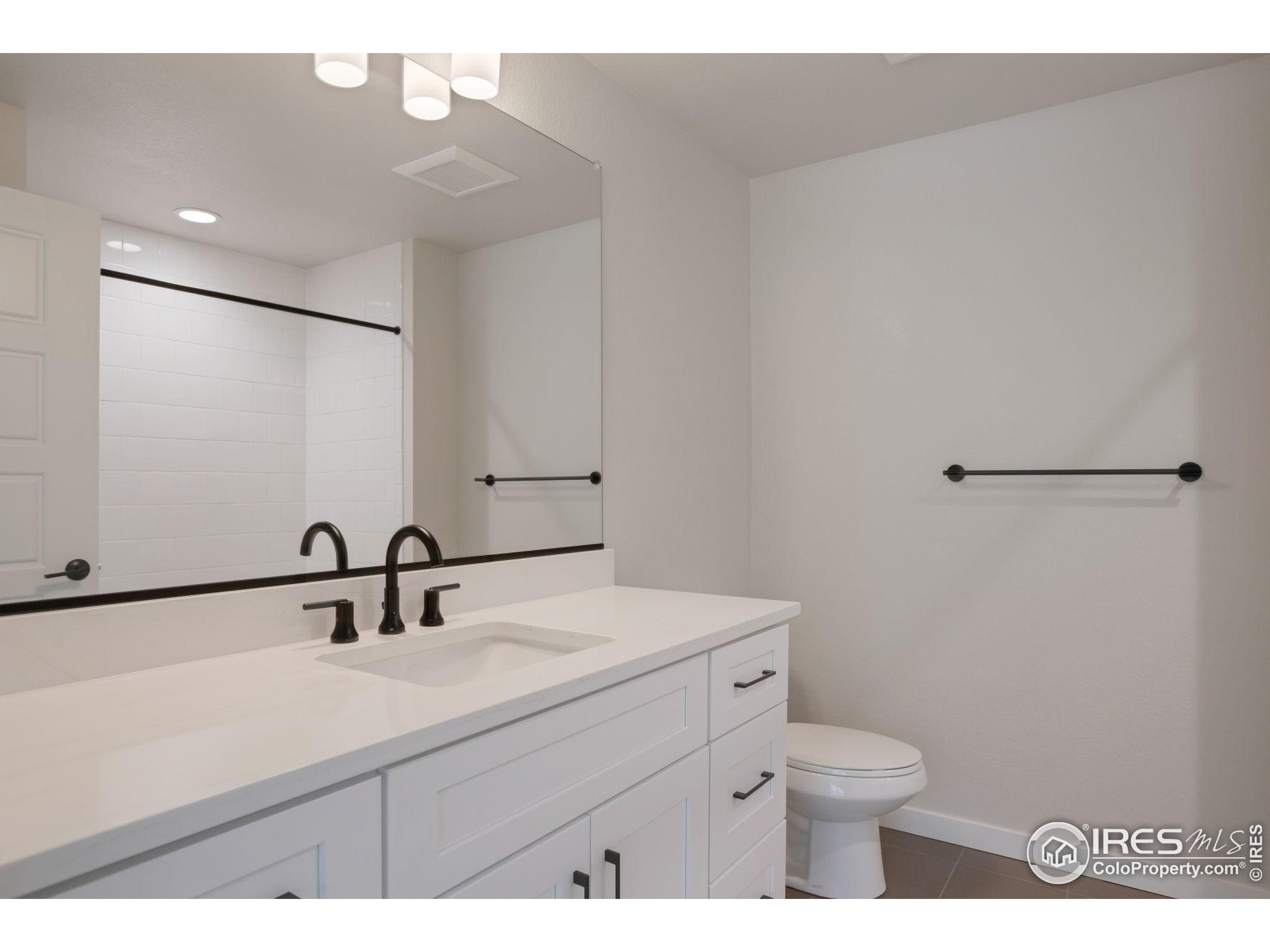 352 Marshall Road Superior, CO 80027 - Photo 8 of 30 a bathroom with a sink a toilet and mirror