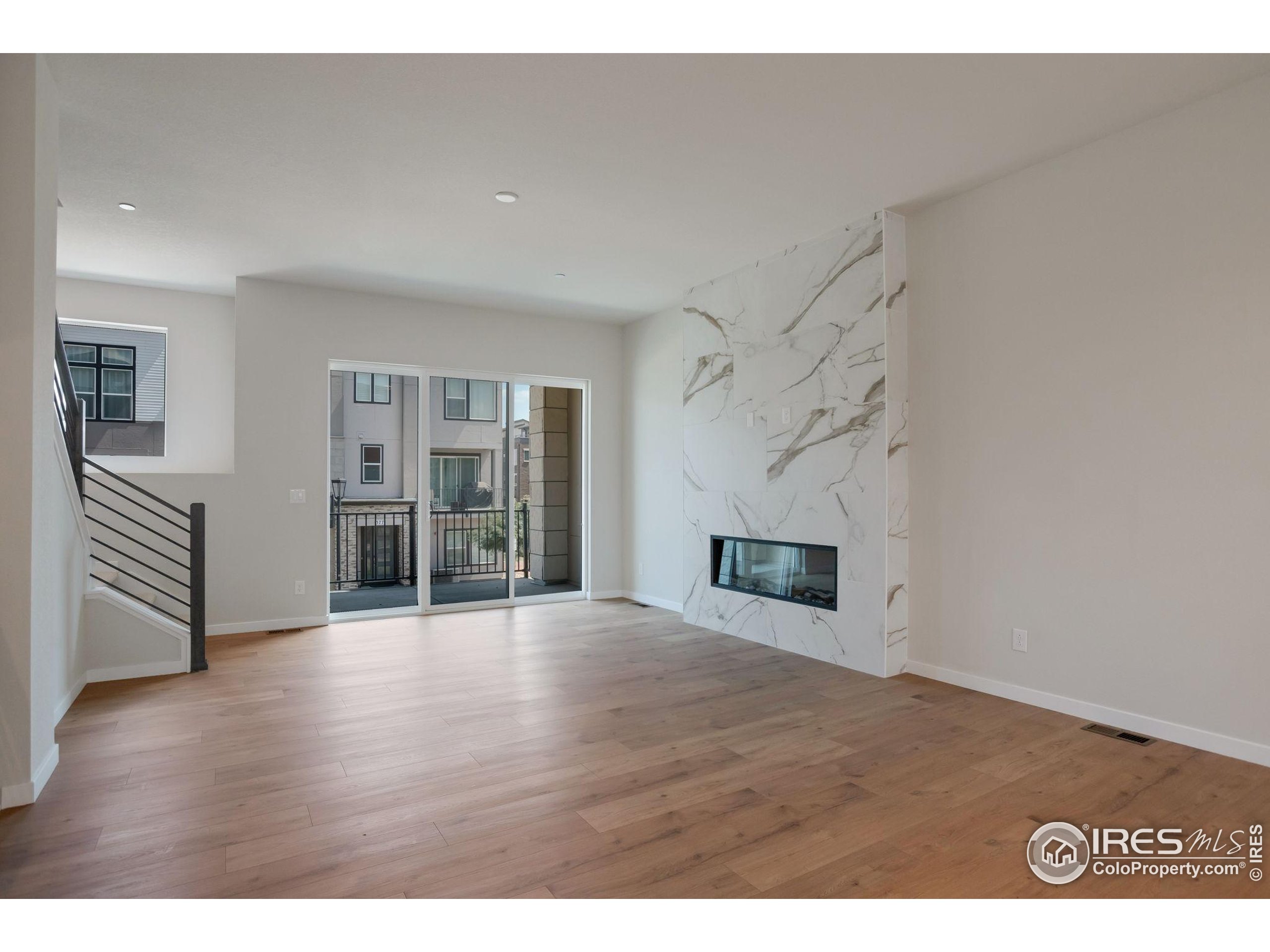 352 Marshall Road Superior, CO 80027 - Photo 9 of 30 a view of a livingroom with wooden floor and a fireplace