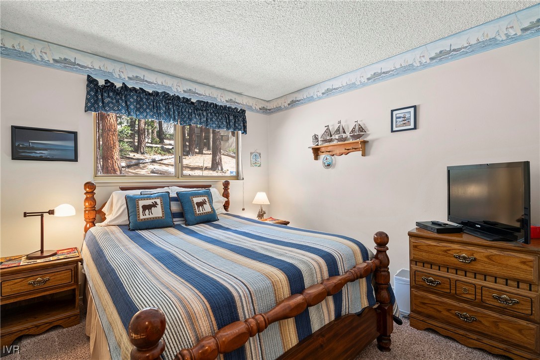 321 Ski Way, Unit 24 Incline Village, NV 89451 - Photo 13 of 31 a bedroom with a bed and a flat screen tv