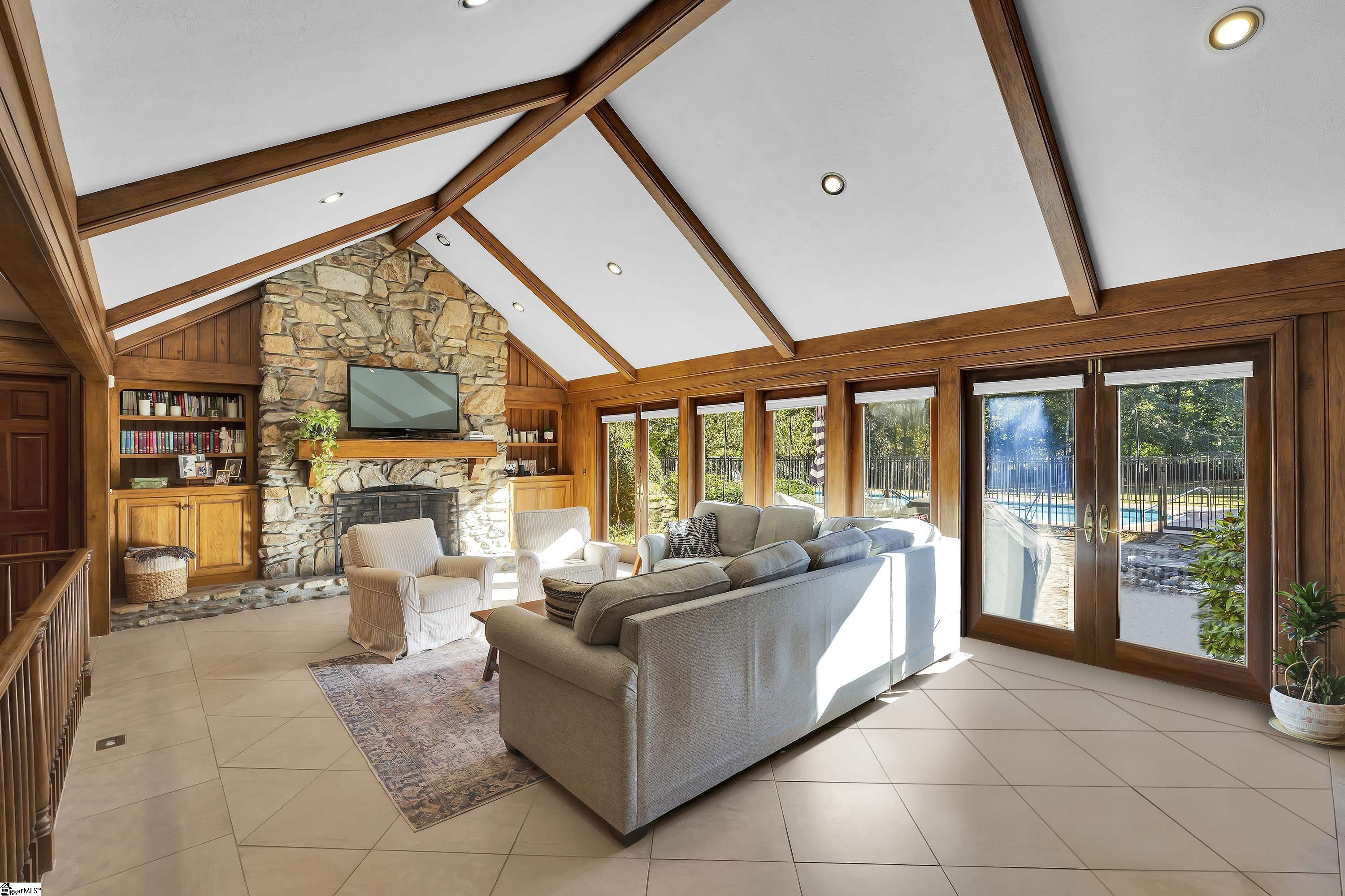 102 Graystone Road Greenville, SC 29615 - Photo 6 of 50 Vaulted Ceiling, built-in's, wetbar and all opens to stone patio