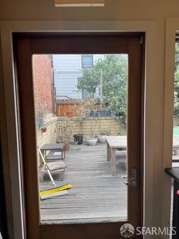 a view of living room with a floor to ceiling window and wooden floor