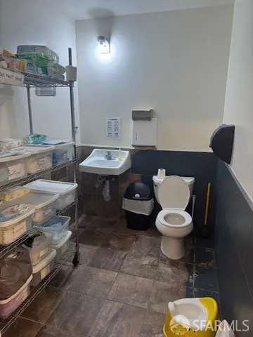 a bathroom with a toilet a sink and a mirror