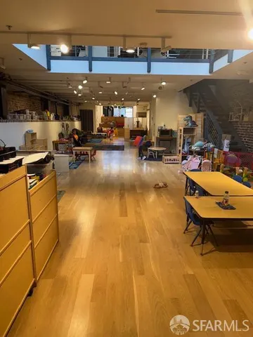 a view of a gym with pool table and chairs