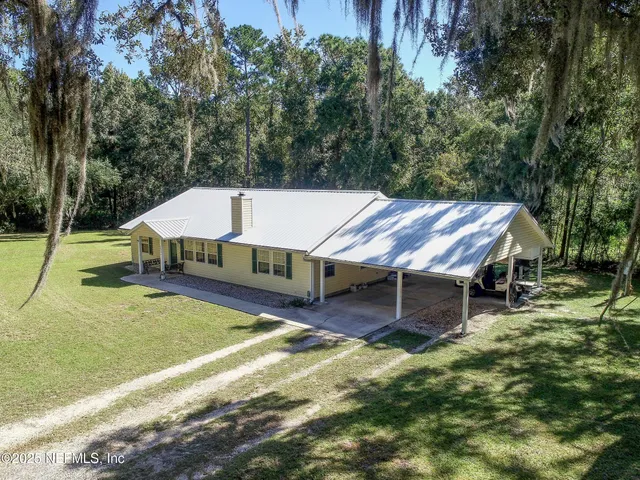 a aerial view of a house with a yard