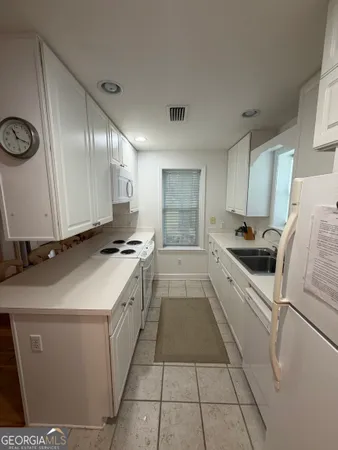 a kitchen that has a sink and a stove in it