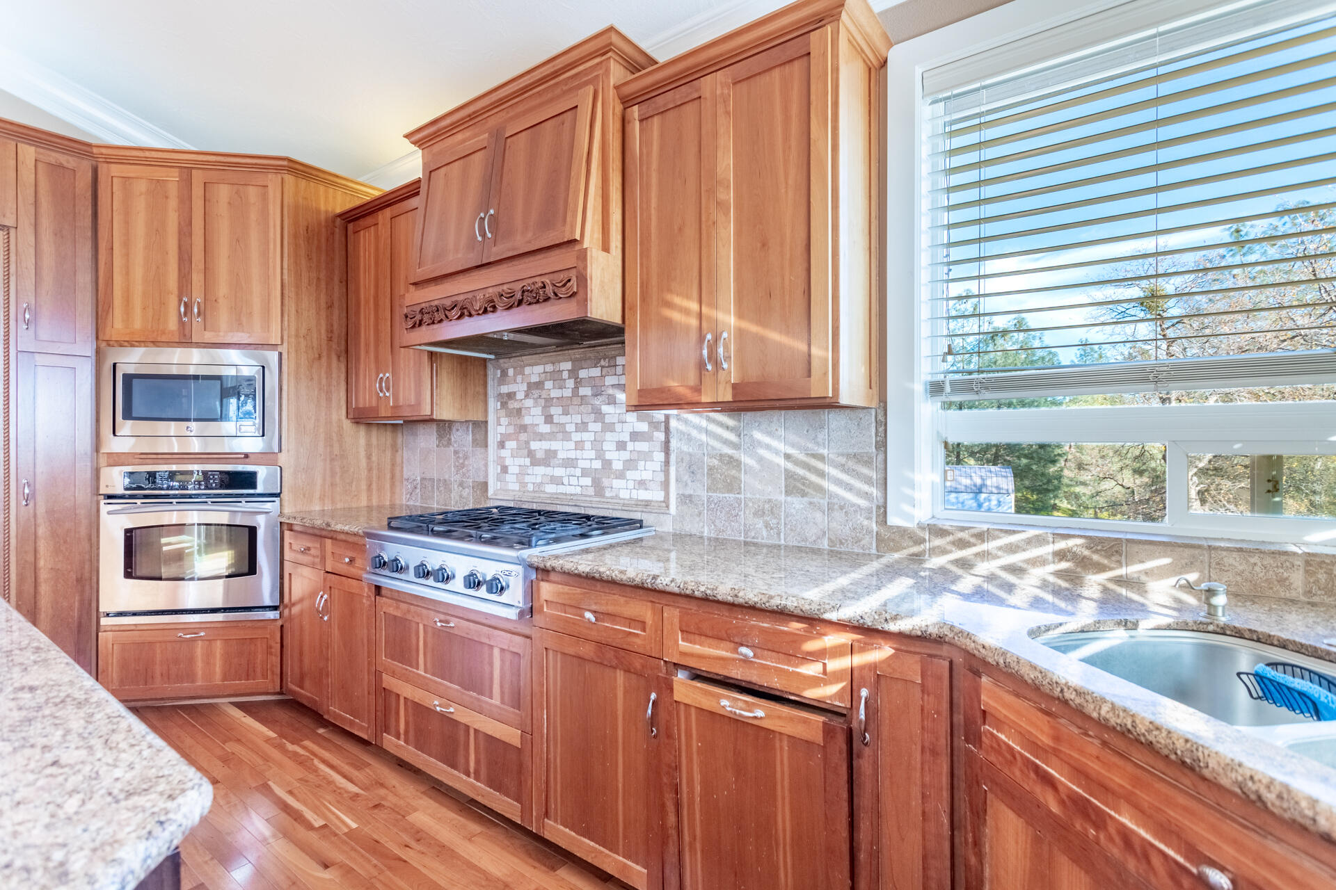 7775 Muletown Road Redding, CA 96001 - Photo 8 of 46 a kitchen with stainless steel appliances granite countertop a sink a stove and a refrigerator