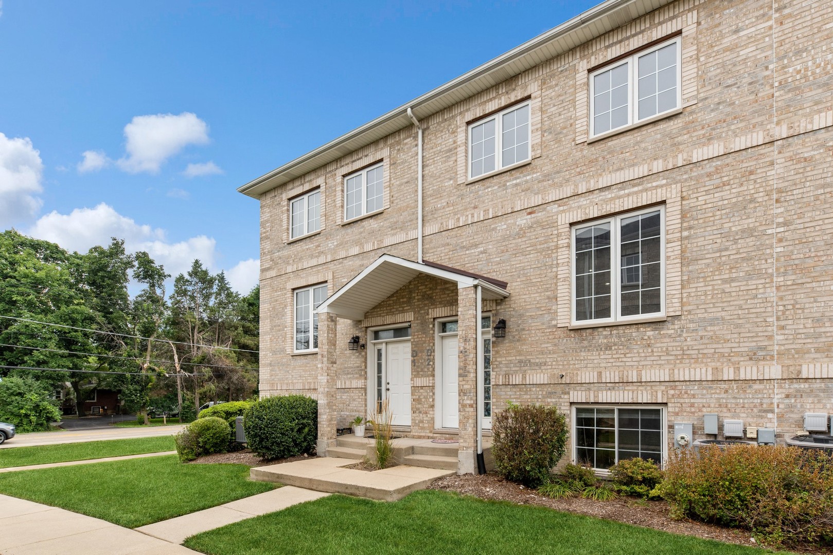 183 East River Road, Unit D2 Des Plaines, IL 60016 - Photo 1 of 42 a front view of a house with a yard