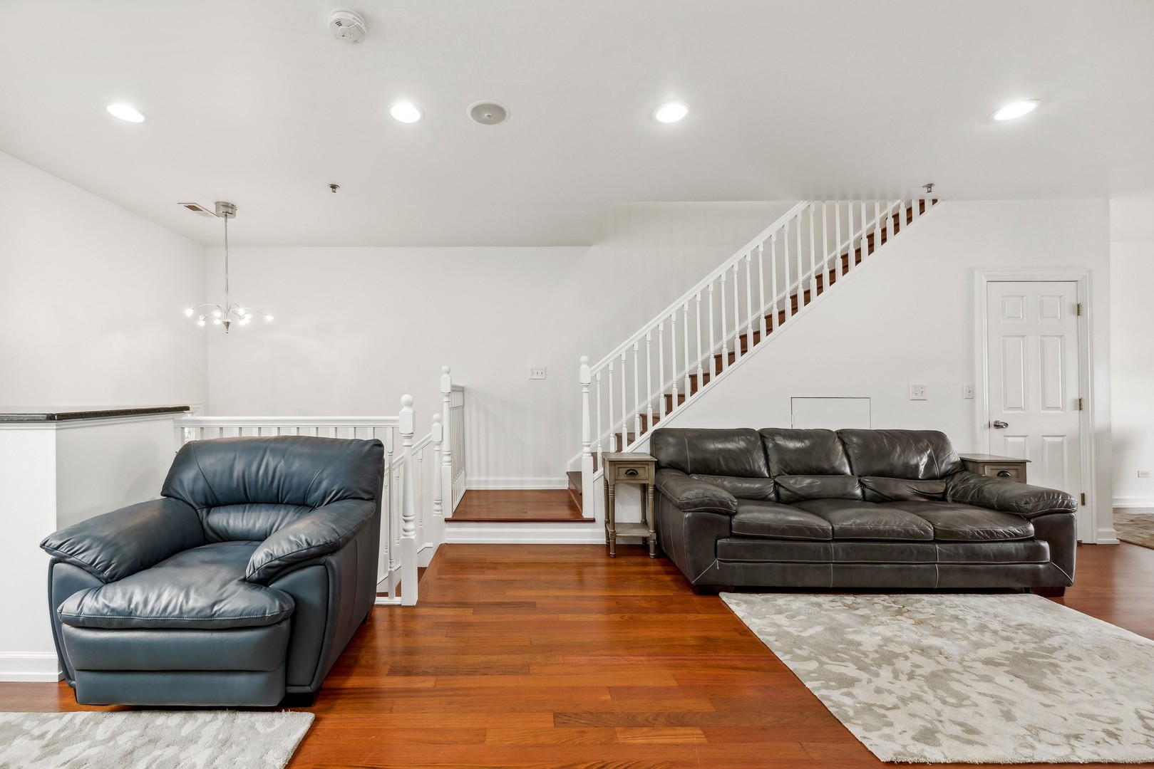183 East River Road, Unit D2 Des Plaines, IL 60016 - Photo 17 of 42 a living room with furniture and stairs