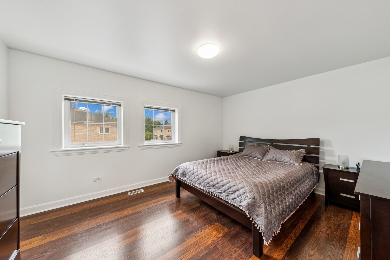 183 East River Road, Unit D2 Des Plaines, IL 60016 - Photo 18 of 42 a bedroom with a bed and wooden floor