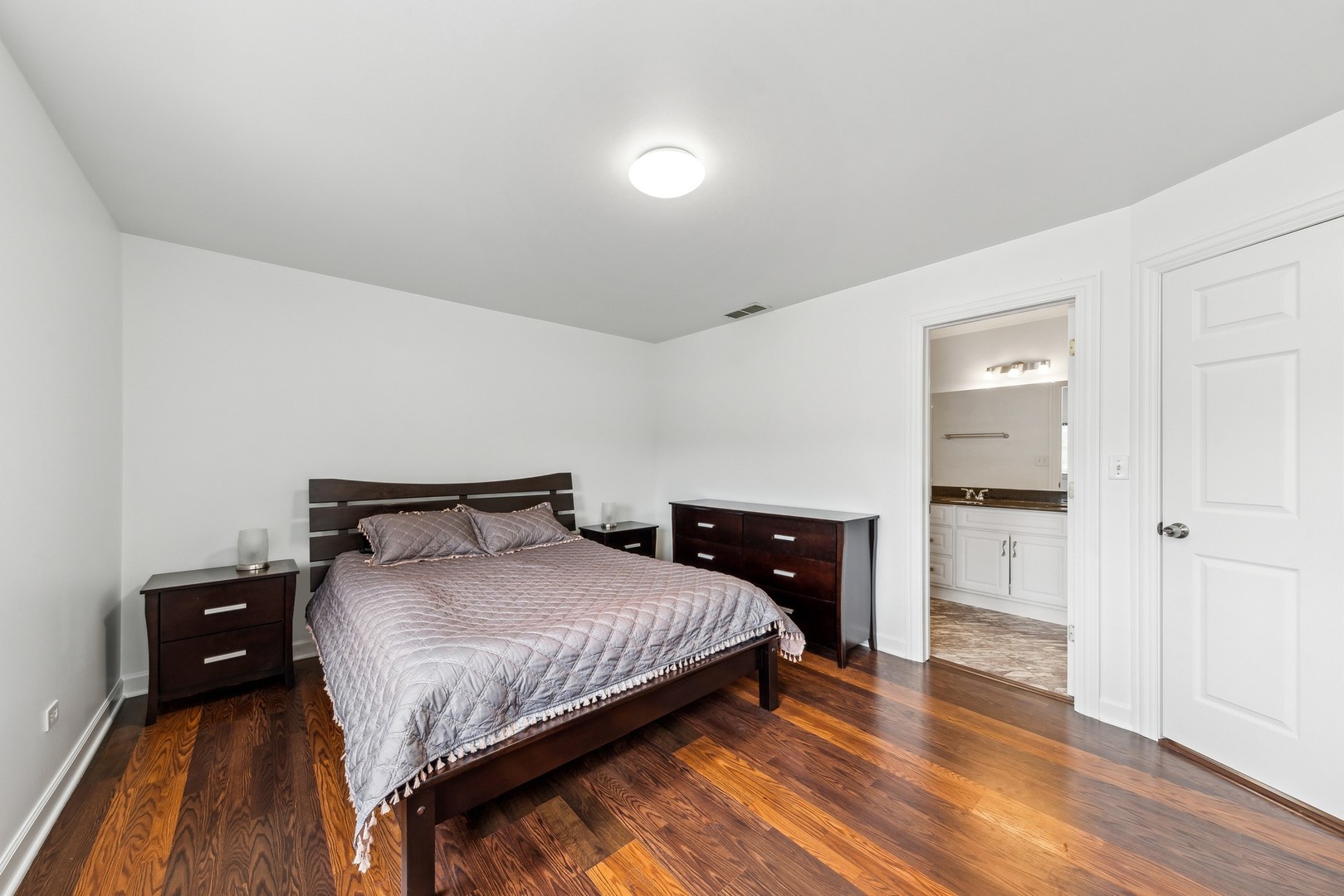 183 East River Road, Unit D2 Des Plaines, IL 60016 - Photo 19 of 42 a bedroom with a bed and wooden floor