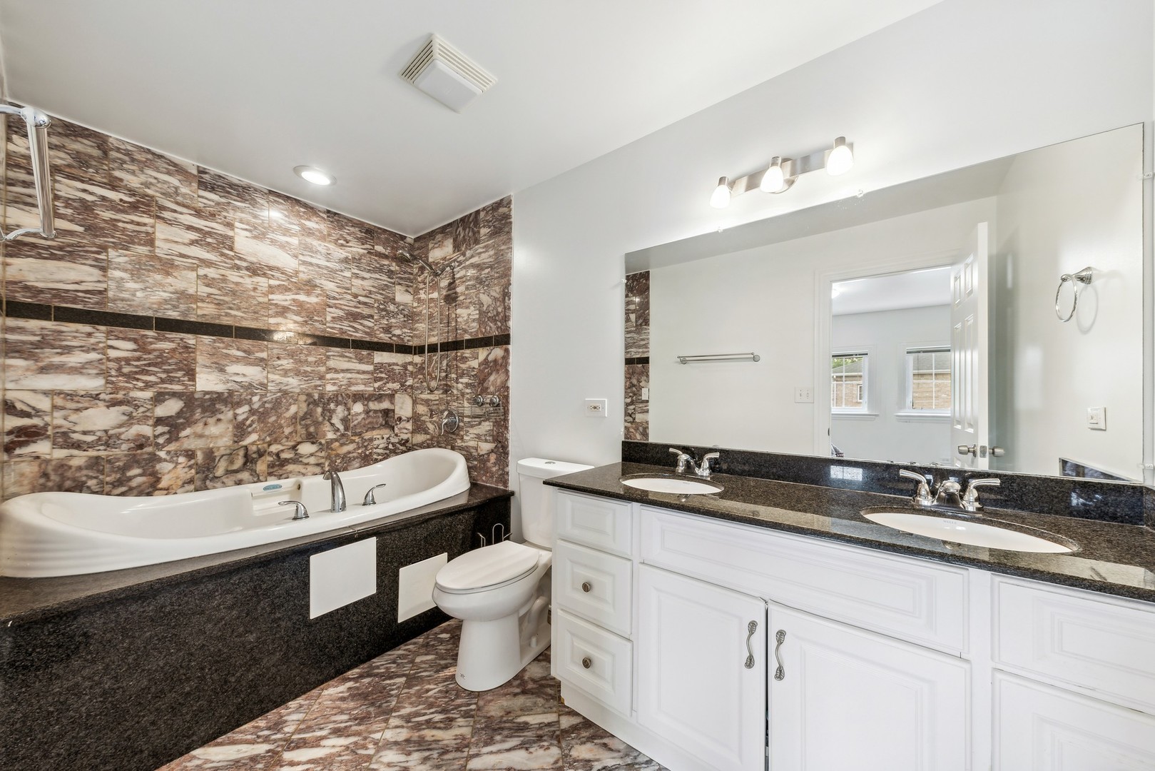 183 East River Road, Unit D2 Des Plaines, IL 60016 - Photo 21 of 42 a bathroom with a toilet sink and mirror