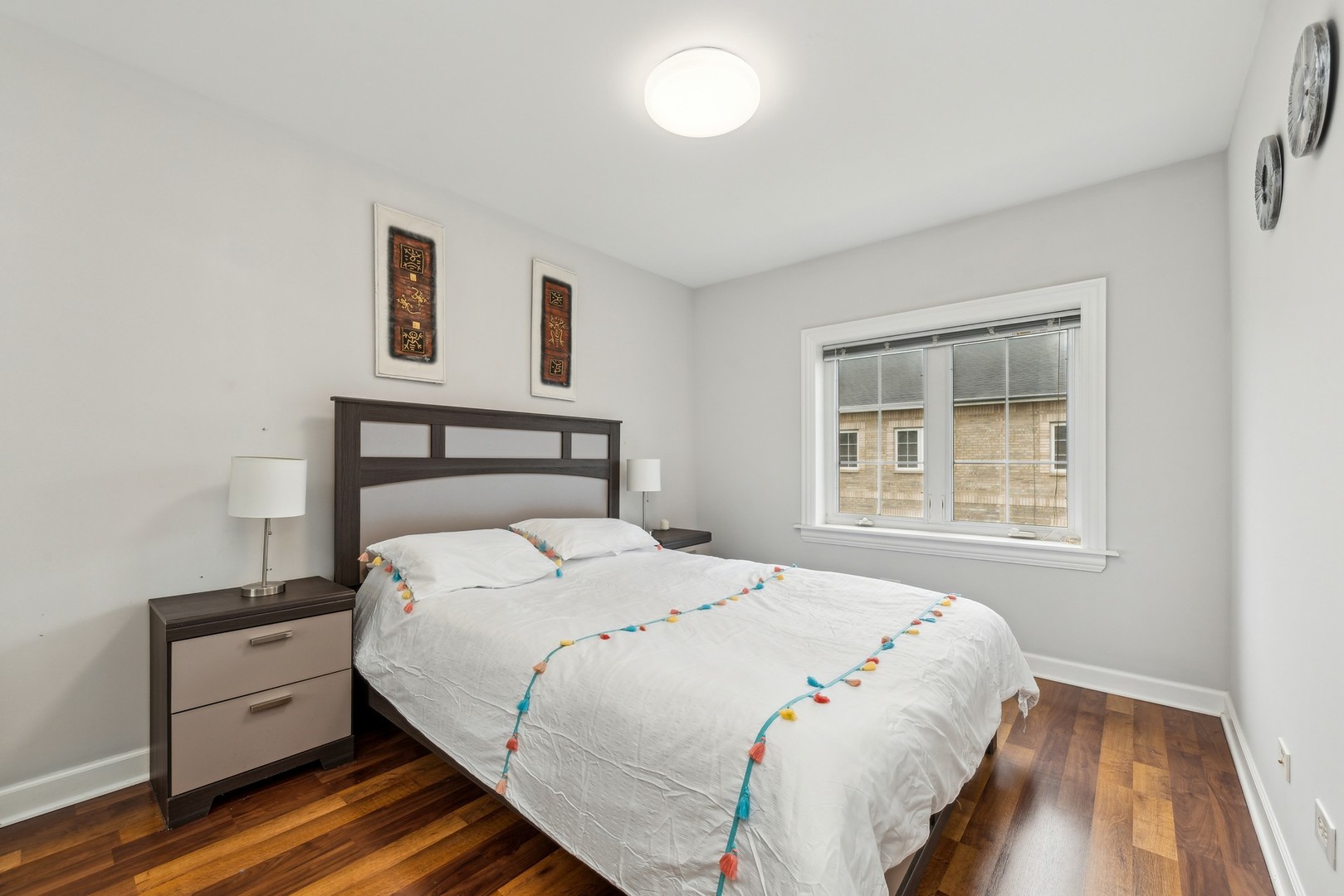 183 East River Road, Unit D2 Des Plaines, IL 60016 - Photo 24 of 42 a bedroom with a bed and a night stand