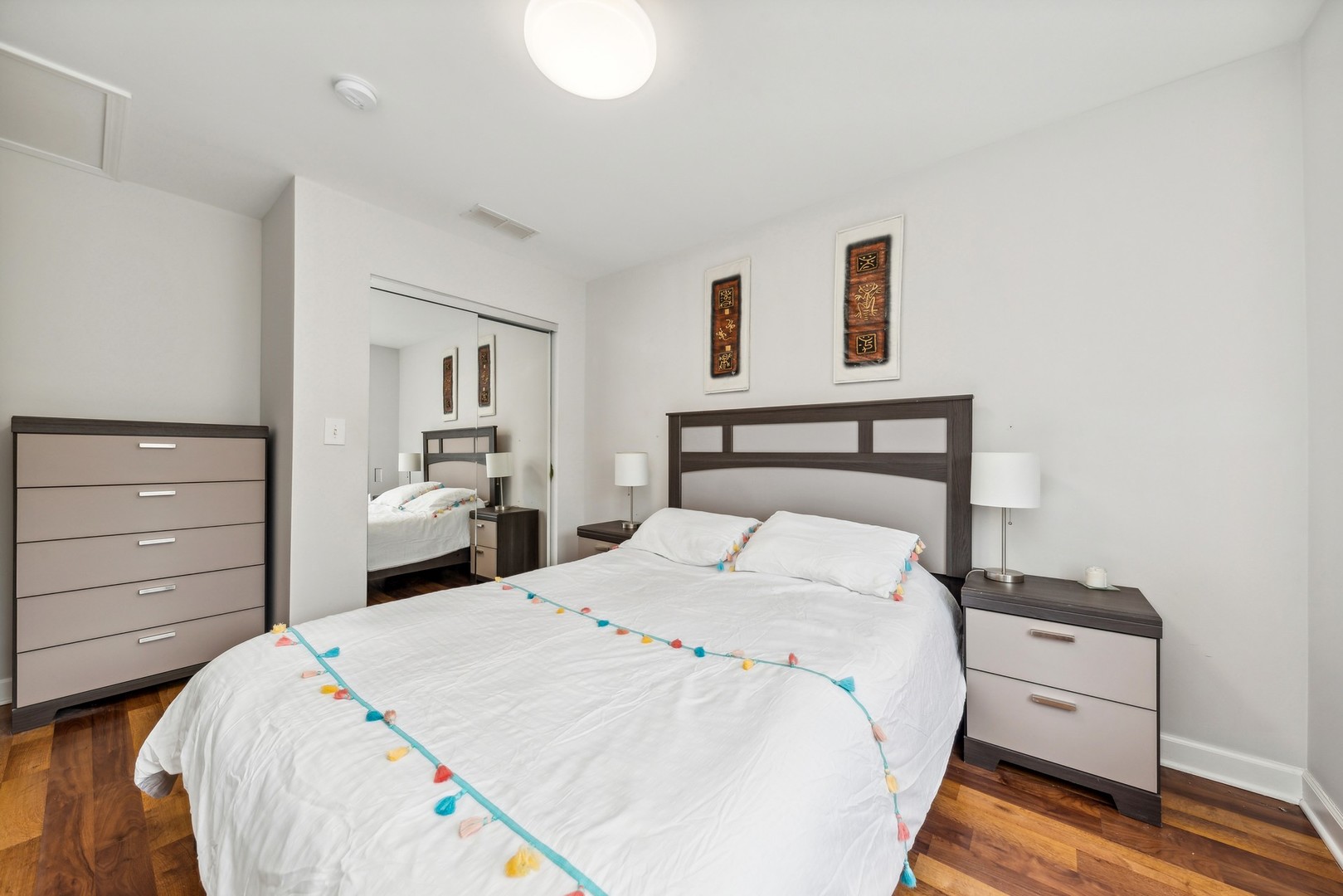 183 East River Road, Unit D2 Des Plaines, IL 60016 - Photo 25 of 42 a bedroom with a bed and a night stand