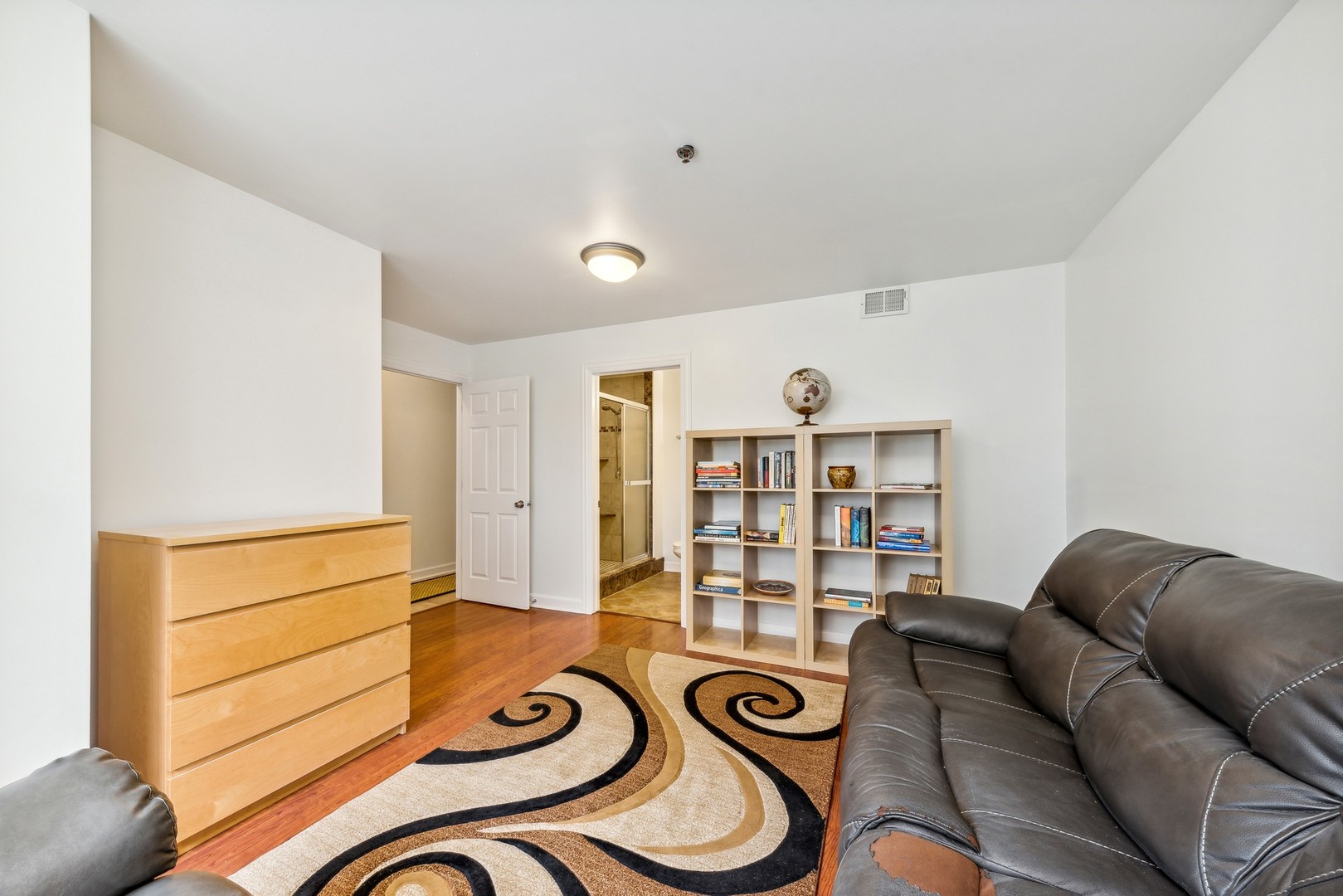 183 East River Road, Unit D2 Des Plaines, IL 60016 - Photo 28 of 42 a living room with furniture and bookshelf