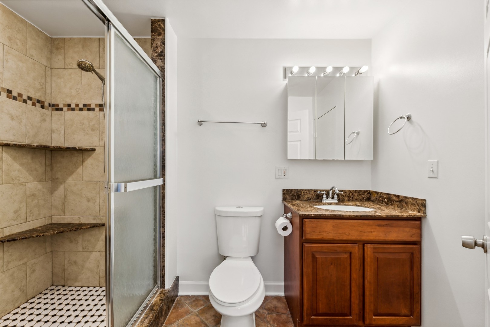 183 East River Road, Unit D2 Des Plaines, IL 60016 - Photo 31 of 42 a bathroom with a toilet sink and shower