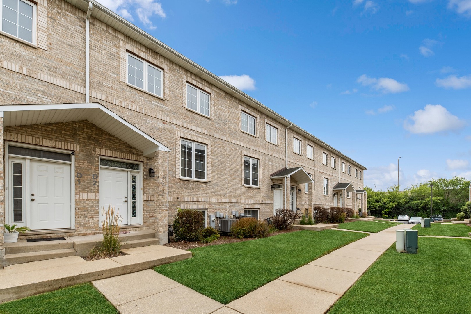 183 East River Road, Unit D2 Des Plaines, IL 60016 - Photo 37 of 42 a front view of a house with a yard