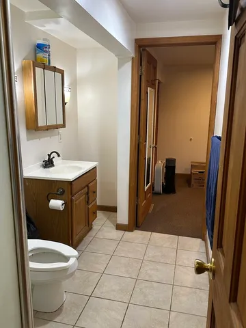 a bathroom with a sink a toilet and mirror