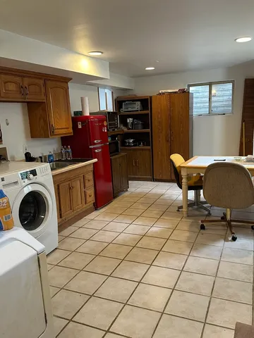 a kitchen with stainless steel appliances kitchen island granite countertop a refrigerator and a stove top oven