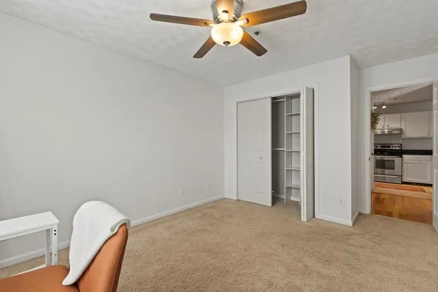 a view of a livingroom with a chandelier fan