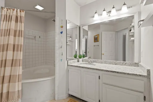 a bathroom with a granite countertop sink mirror and double