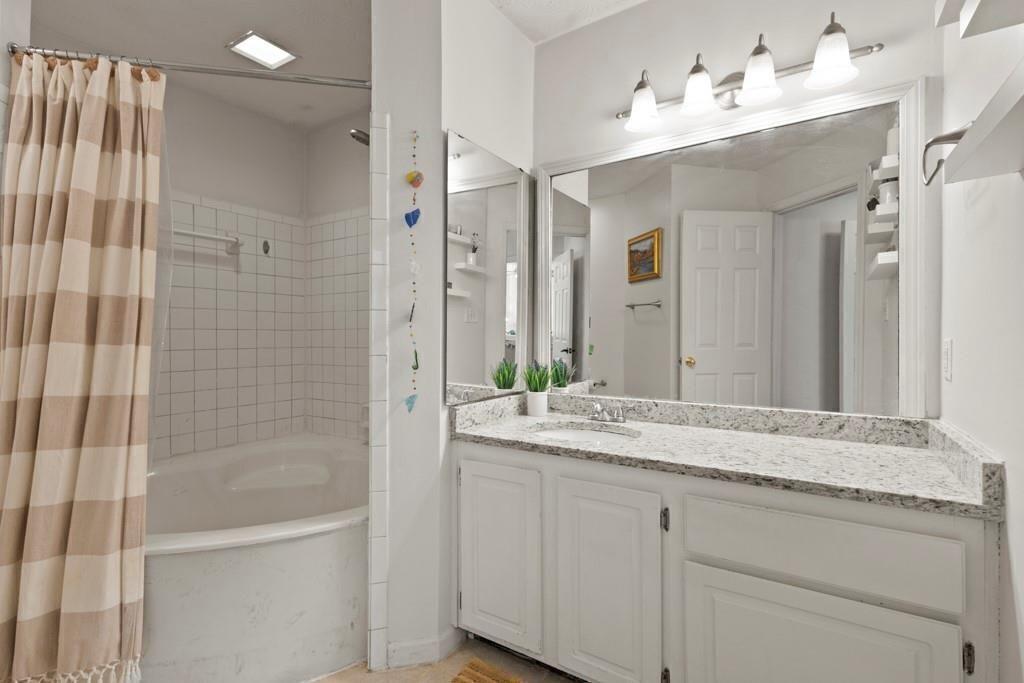 970 Sidney Marcus Boulevard Northeast, Unit 2408 Atlanta, GA 30324 - Photo 17 of 27 a bathroom with a granite countertop sink mirror and double