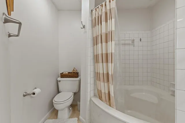a bathroom with a bathtub and toilet