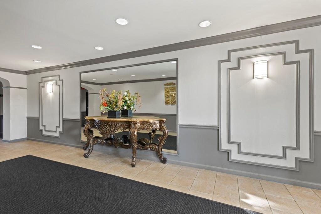 970 Sidney Marcus Boulevard Northeast, Unit 2408 Atlanta, GA 30324 - Photo 22 of 27 a living room with furniture and a potted plant