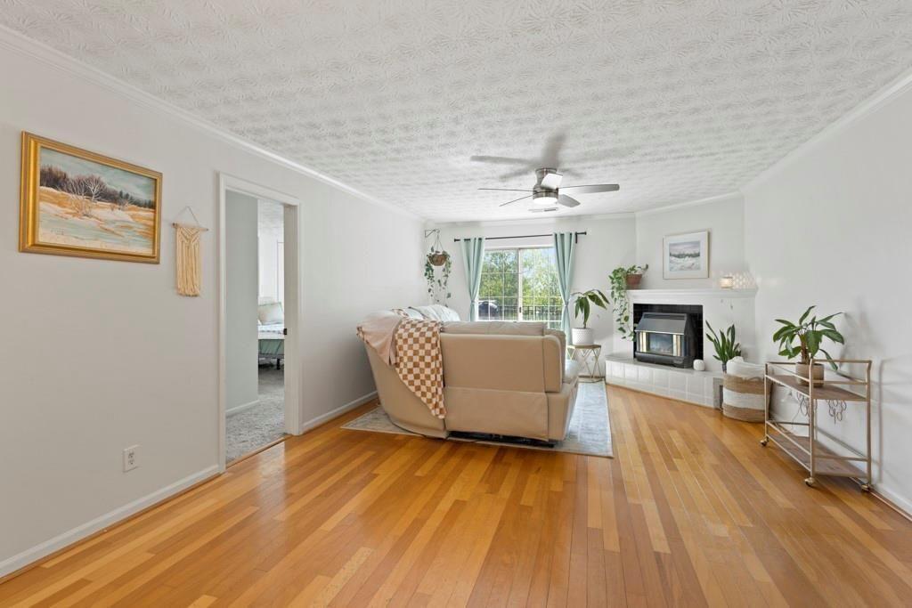 970 Sidney Marcus Boulevard Northeast, Unit 2408 Atlanta, GA 30324 - Photo 3 of 27 a living room with furniture and a fireplace