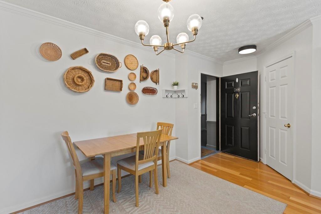970 Sidney Marcus Boulevard Northeast, Unit 2408 Atlanta, GA 30324 - Photo 4 of 27 a view of a dining area with furniture and wooden floor