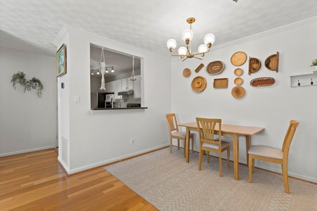 970 Sidney Marcus Boulevard Northeast, Unit 2408 Atlanta, GA 30324 - Photo 5 of 27 a view of a dining room with furniture and wooden floor