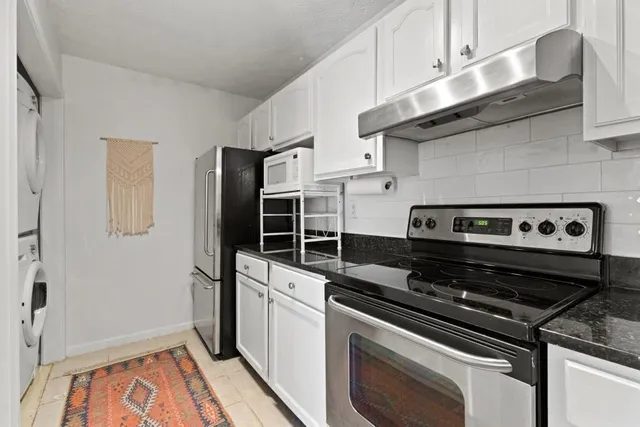 a kitchen with wooden cabinets and a stove top oven