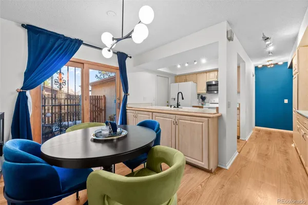 a kitchen with a table chairs and a wooden floor