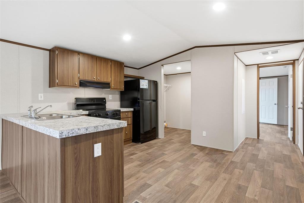 618 East 6th Street, Unit B Blum, TX 76627 - Photo 6 of 24 a kitchen with a sink stove and refrigerator
