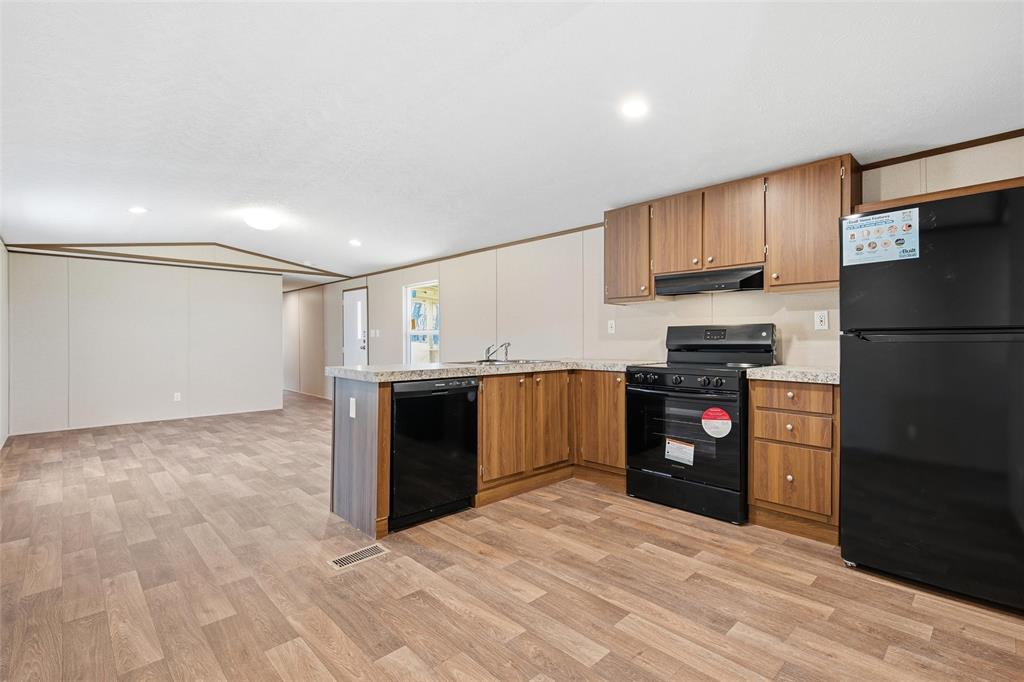 618 East 6th Street, Unit B Blum, TX 76627 - Photo 7 of 24 a kitchen with a refrigerator and a stove top oven