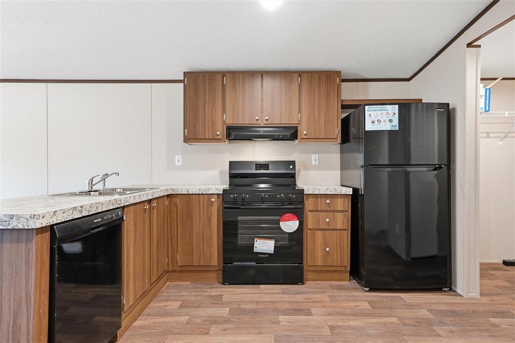 618 East 6th Street, Unit B Blum, TX 76627 - Photo 8 of 24 a kitchen with stainless steel appliances granite countertop a refrigerator and a stove
