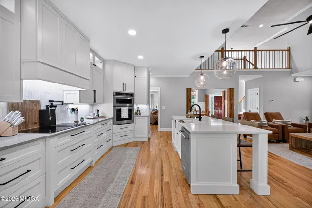 a large kitchen with stainless steel appliances kitchen island granite countertop a large counter top and stainless steel appliances