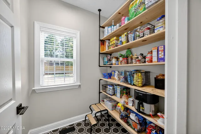 a room with book shelf and a window