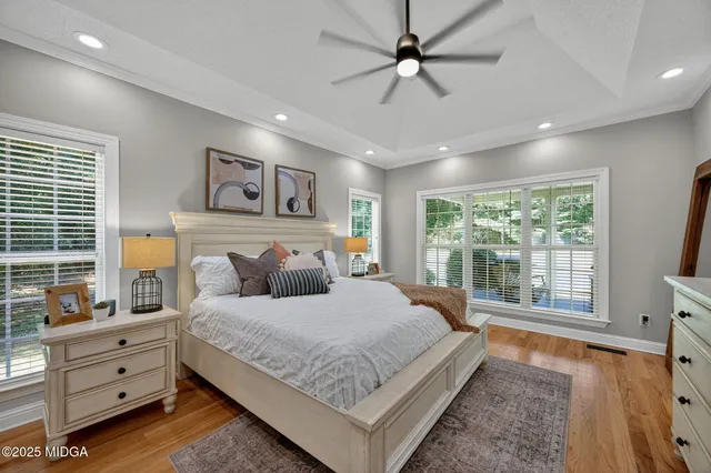 a bedroom with a large bed and a large window